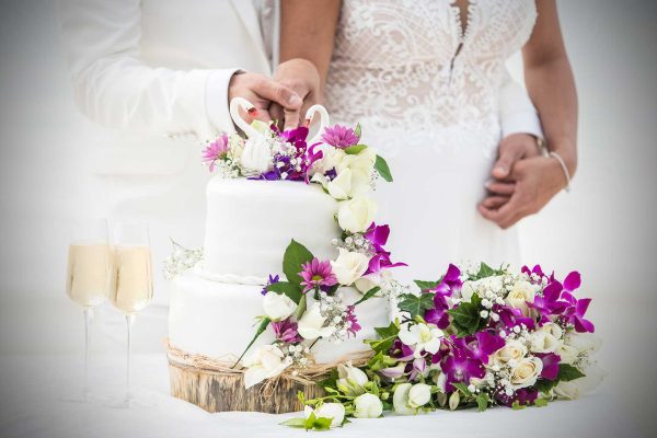 Nice wedding cake with violet flowers and champagne