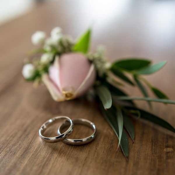 nice wedding rings with flower in background