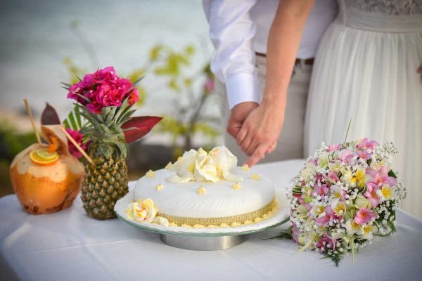 exotic wedding cake cutting with ananas and coconut drinks