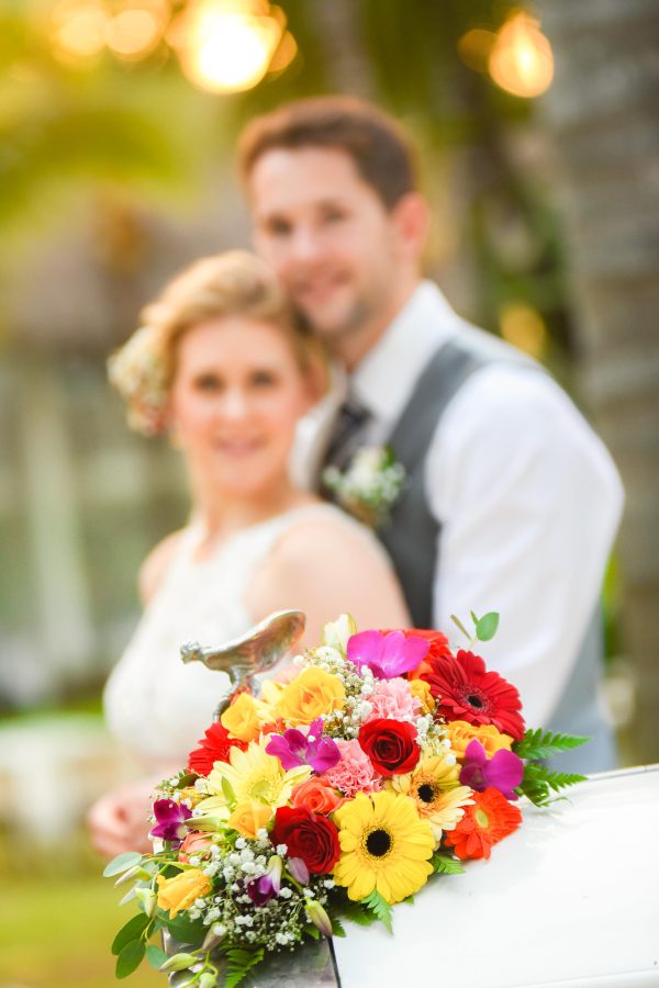 awesome wedding couple posing with bouquet