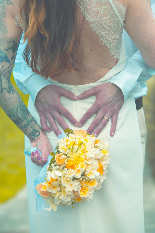 groom making heart with hands