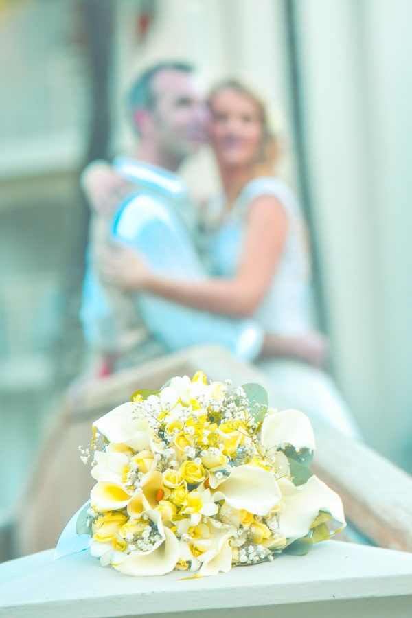 wedding couple posing at the back yellow bouquet
