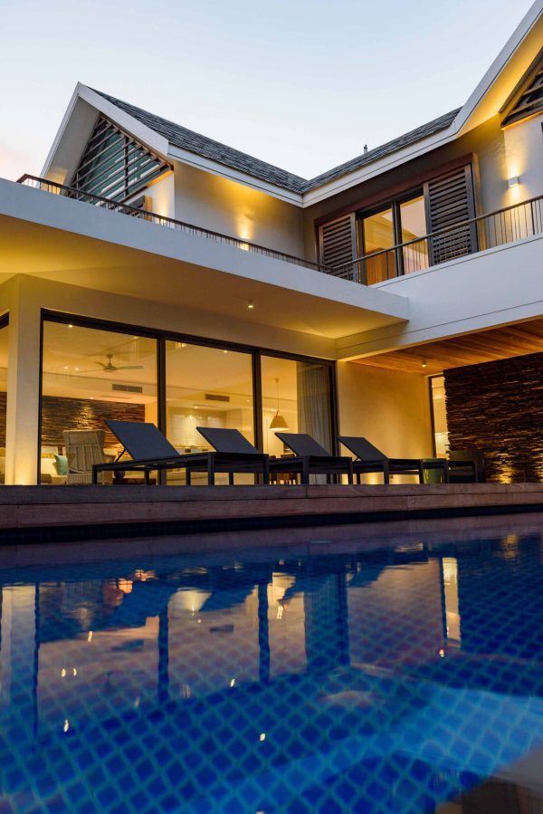 real estate house at night with modern infrastructure and big pool